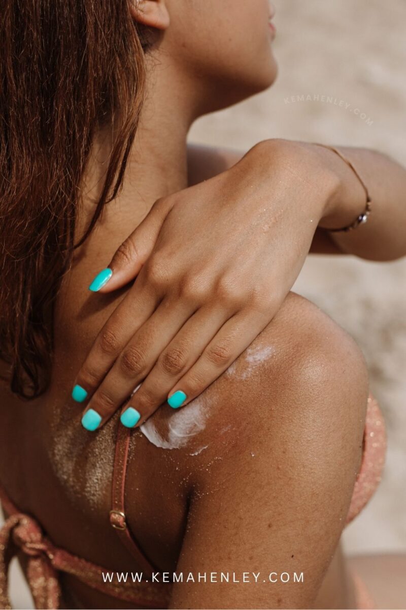 tan girl applying sunscreen