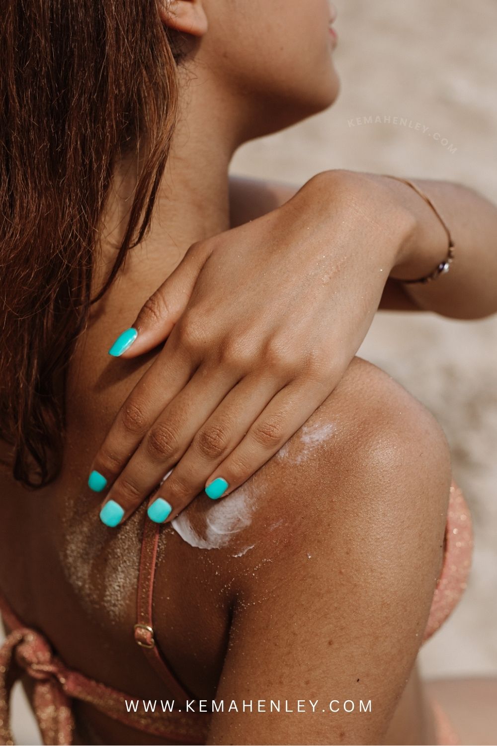 tan girl applying sunscreen